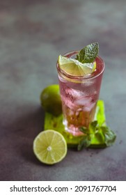 A Fresh Pink Cocktail Or Mocktail Drink With Lime, Pink Grapefruit Juice And Mint, Green Background. Paloma.