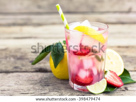 Fresh pink lemonade with lemon, lime and strawberries 