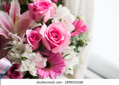 Fresh pink rose flowers bouquet in a natural soft light tone and copy space with selective focus.