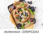 Fresh pizza with figs, mozzarella, grapes and basil	