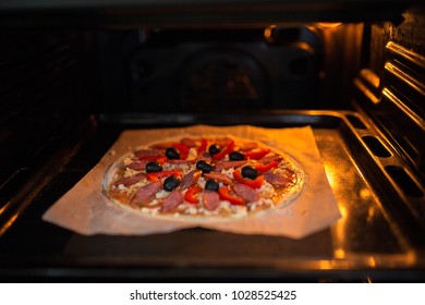 Fresh Pizza On A Metal Baking Tray In Hot Oven