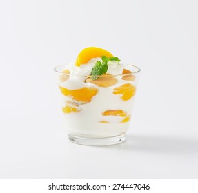 fresh plain yogurt with pieces of apricot, served in the glass