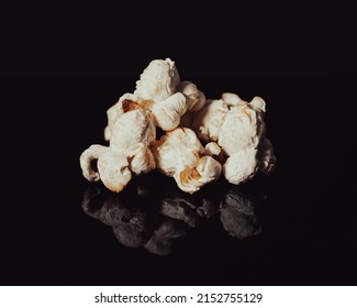 Fresh Popcorn Isolated On A Black Mirror Surface