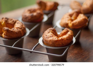 Fresh popover muffins served on a rustic wooden table - Powered by Shutterstock