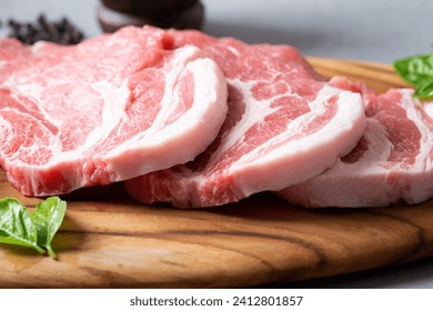 Fresh pork neck on wooden cutting board - Powered by Shutterstock