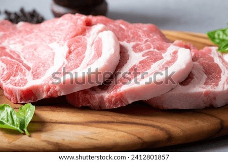 Fresh pork neck on wooden cutting board
