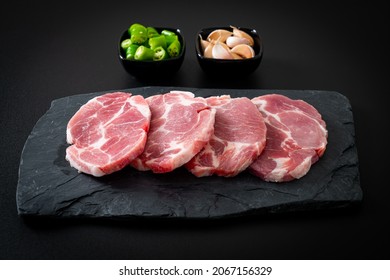 fresh pork neck raw or collar pork on board with ingredients for marinated