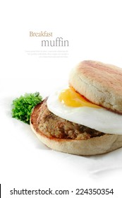 A Fresh Pork Sausage Patty And Fried Egg Breakfast Muffin Against A White Background. Copy Space.