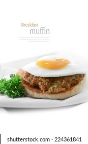 A Fresh Pork Sausage Patty And Fried Egg Breakfast Muffin Against A White Background. Copy Space.