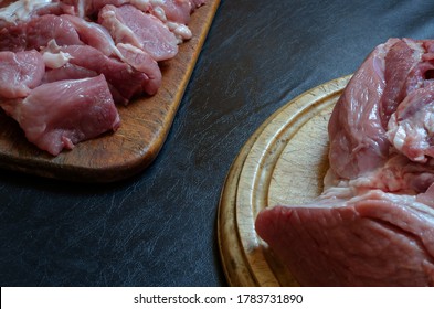 Fresh Pork Tenderloin On A Cutting Board. Whole Raw Sacrum And Pork Goulash. Trade In Meat Or Cooking Meat Dishes.