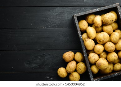 Fresh potatoes in the box. Organic food. Top view. Free space for text. - Powered by Shutterstock