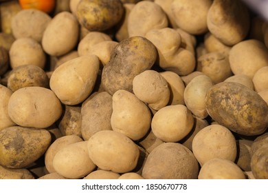 Fresh Potatoes On The Counter Top View Close-up. Harvest Farm Potatoes In The Market. Retail Trade In Vegetables. Soft Focus, Top View.