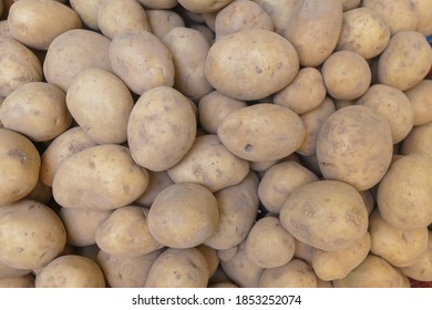 Fresh Potatoes On The Counter Top View Close-up. Harvest Farm Potatoes In The Market. Retail Trade In Vegetables. Soft Focus, Top View.