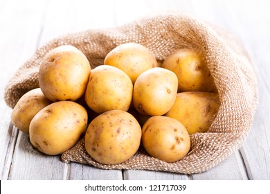  fresh potatoes on wooden table