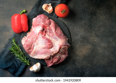 Fresh Poultry Meat. Turkey Thigh On A Dark Background Top View With Copy Space.