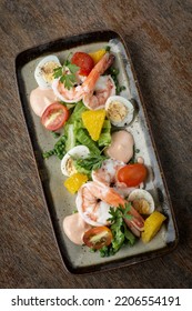 Fresh Prawn And Egg Salad On Rustic Wood Table