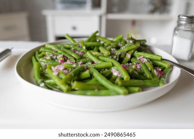 Fresh prepared green bean salad with onions and vinegar, oil dressing