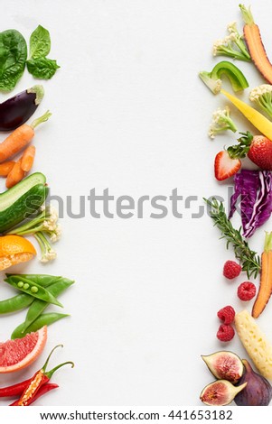 Fresh produce background side border of organic produce colourful fruit and veg, carrot chilli cucumber purple cabbage spinach rosemary herb, poster