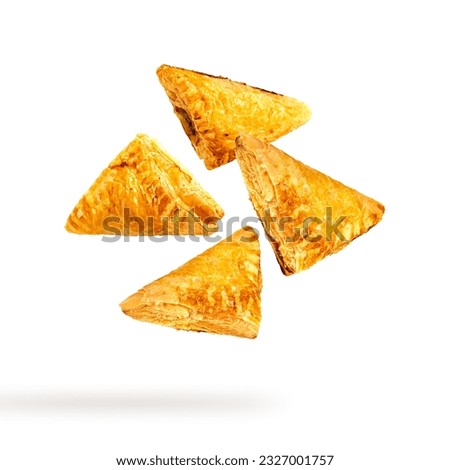 Fresh puff pastry falling isolated on white background.
