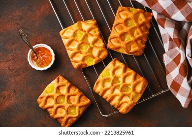 Fresh Puff Pastry Mini Pies With Pear And Lime Jam Filling On Roasting Rack On Dark Background, Horizontal View From Above, Flatlay