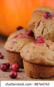 Fresh Pumpkin Cranberry Muffins With Pumpkin In Background