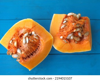 Fresh Pumpkin Cut Open On Blue Background