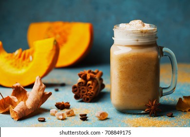 Fresh Pumpkin Spiced Latte Or Coffee In Cup Decorated Cinnamon On Blue Vintage Background. Autumn, Fall Or Winter Hot Drink. Cozy Breakfast.