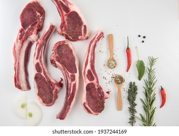 fresh rack of lamb, spices and herbs on a white background - Shutterstock ID 1937244169