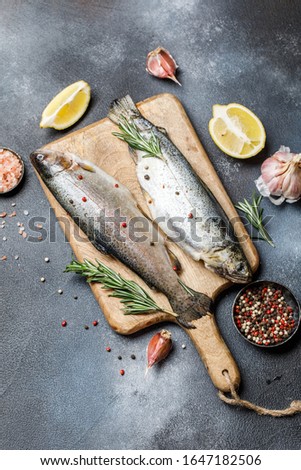 Fresh rainbow trout with spices and ingredient for cooking