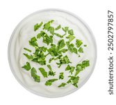 Fresh ranch sauce or greek yogurt tzatziki sauce in a bowl  isolated on white background.Ssour cream dip sauce with herbs top view. Flat lay