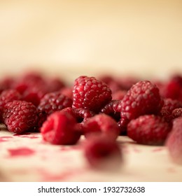 Fresh Raspberries background or texture. Close up shot. Group of red berries at table. Natural organic Healthy food. Sweet summer vegetarian or vegan dessert. Square format,1x1.