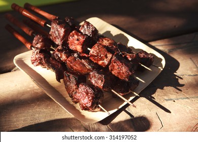 fresh raw beef fillet steak red meat brisket on skewers barbecue brazier grid full burned charcoal
