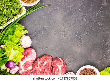 fresh raw beef marble meat with vegetables and sprouts of flax microgrid on a dark stone background. the concept of a healthy lifestyle