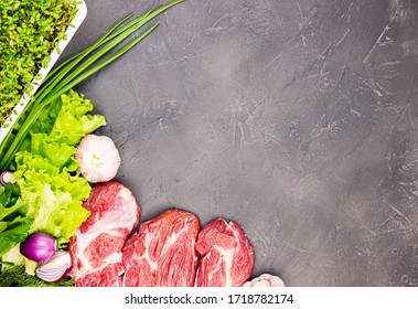 fresh raw beef marble meat with vegetables and sprouts of flax microgrid on a dark stone background. the concept of a healthy lifestyle