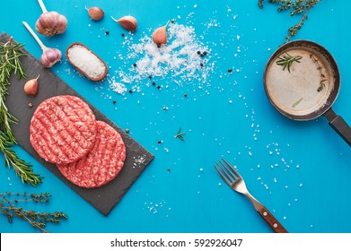 Fresh Raw Beef Meat With Herbs And Salt On Turquoise Background. Flat Lay.