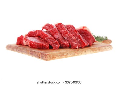 fresh raw beef meat steak slices on wooden cut board isolated over white background