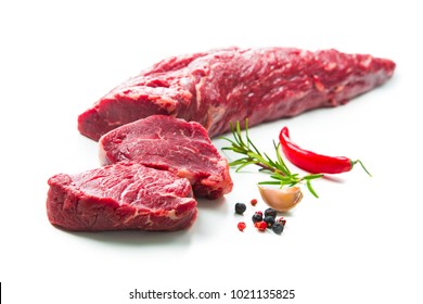 Fresh and raw beef meat. Whole piece of tenderloin with steaks and spices ready to cook isolated on white background