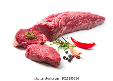 Fresh and raw beef meat. Whole piece of tenderloin with steaks and spices ready to cook isolated on white background
