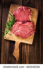 Fresh Raw Beef Steak Sirloin With Rosemary On Cutting Board. Top View