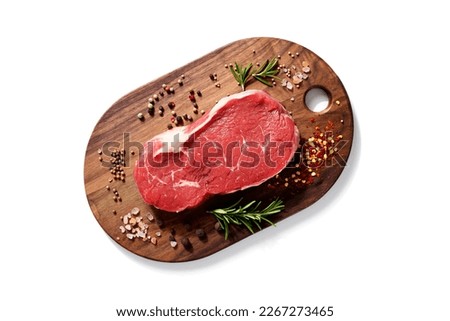 Fresh raw beef steak with spices isolated on white background. top view