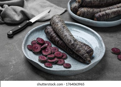 Fresh Raw Black Carrots On Grey Plate