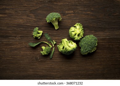 Fresh Raw Broccoli On A Wooden Background Overhead Shoot.