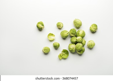 Fresh raw Brussels sprouts isolated on a white background.