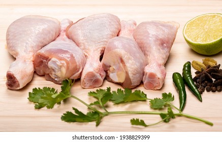 Fresh Raw chicken legs isolated on a Wooden background