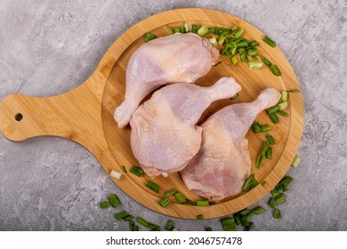 Fresh Raw Chicken Legs On Wooden Cutting Board. Whole Chicken Leg. Raw Meat Products.