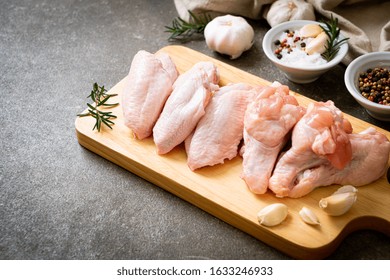 Fresh Raw Chicken Wings On Wooden Board With Ingredients