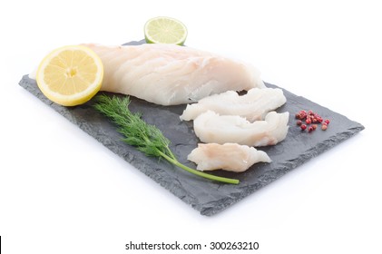 Fresh Raw Cod Fillet On A Slate Plate, Isolated On White