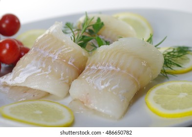 Fresh Raw Cod Fish Fillet On A Plate With Parsley And Lemon 