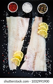 Fresh Raw Cod With Herbs Served On Black Stone 