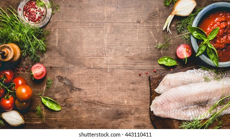 Fresh Raw Fish Fillet With Tomatoes ,sauce And Cooking Ingredients On Rustic Wooden Background, Top View, Banner. Healthy Or Diet Food Concept